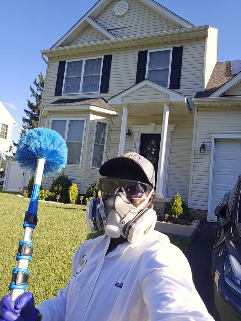 Trained specialist treating a home foundation against insects.